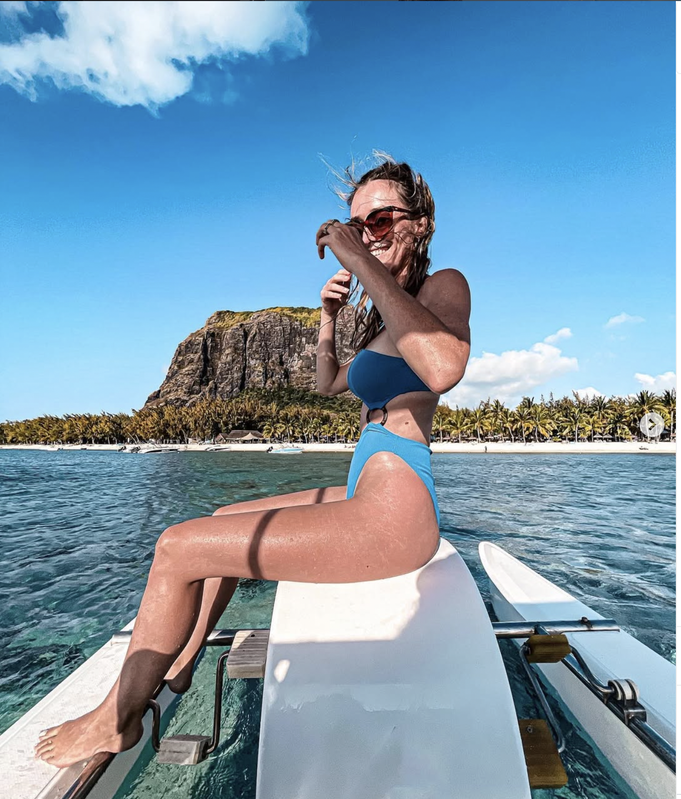 Carlijn on a boat with Le Morne mountain in the background