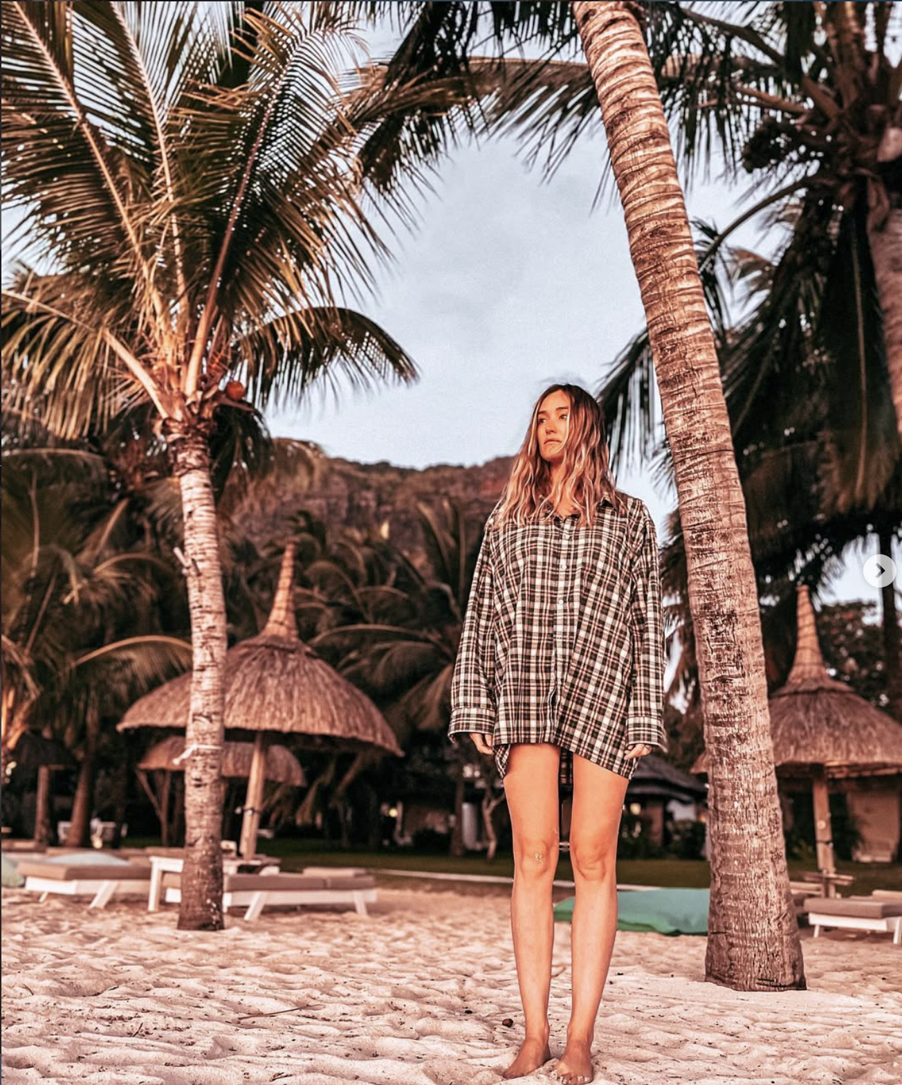 Carlijn standing under palm trees at a Mauritius beach resort