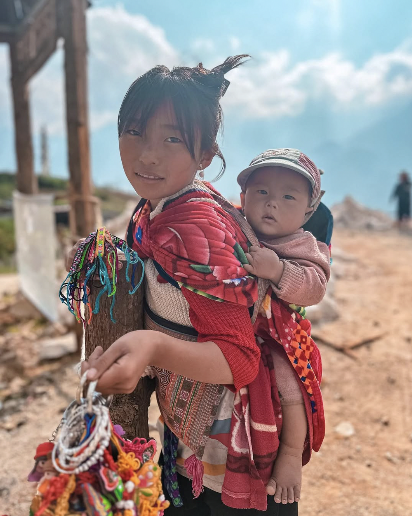 Young girl carrying a baby in the mountain villages of Sapa, Vietnam