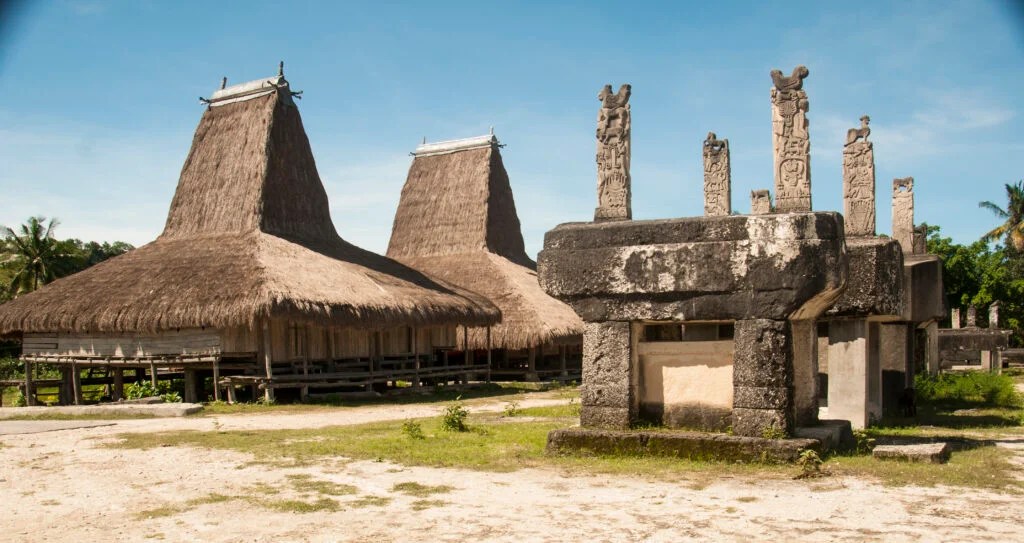 Traditional thatched houses and stone tombs in Rende Village, East Sumba