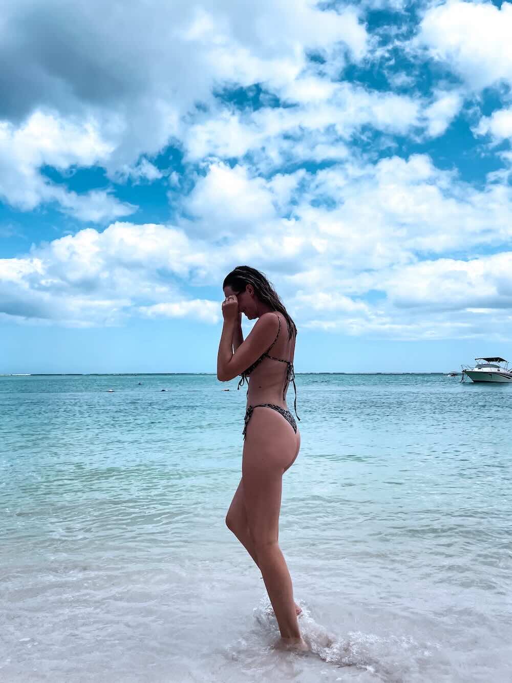 Woman swimming in the warm turquoise lagoon in Mauritius.