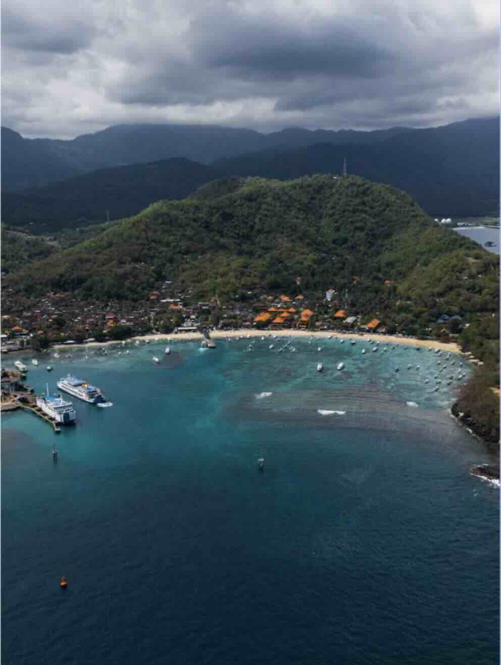 Aerial view of Blue Lagoon near Padang Bai with turquoise water and coastal hills in Bali