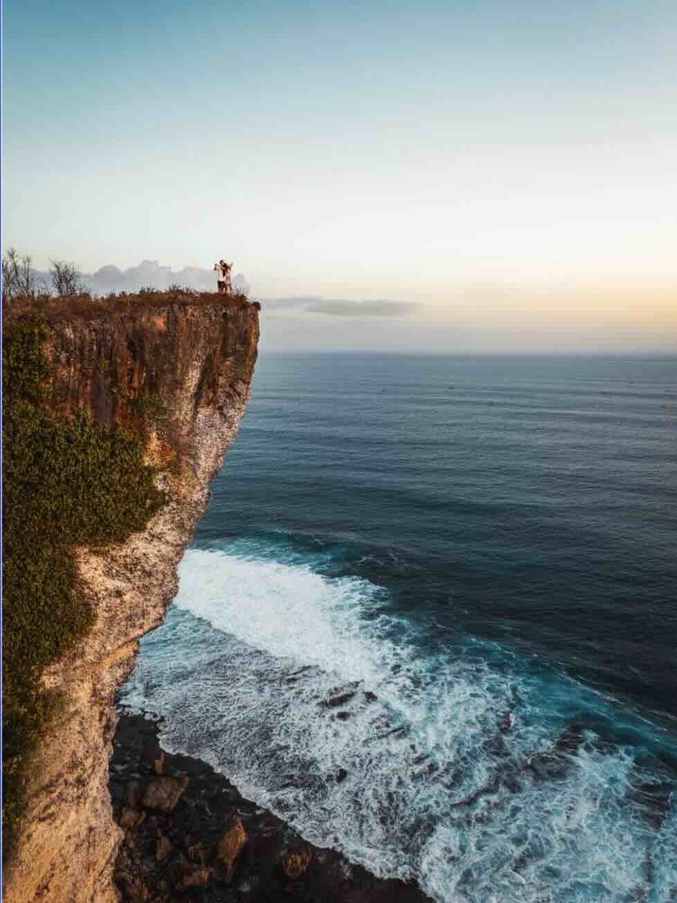 High cliff viewpoint overlooking the ocean at sunset in Uluwatu, Bali