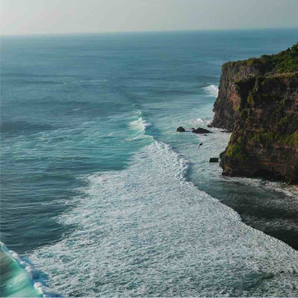 Ocean waves below the cliffs near Uluwatu Temple in Bali