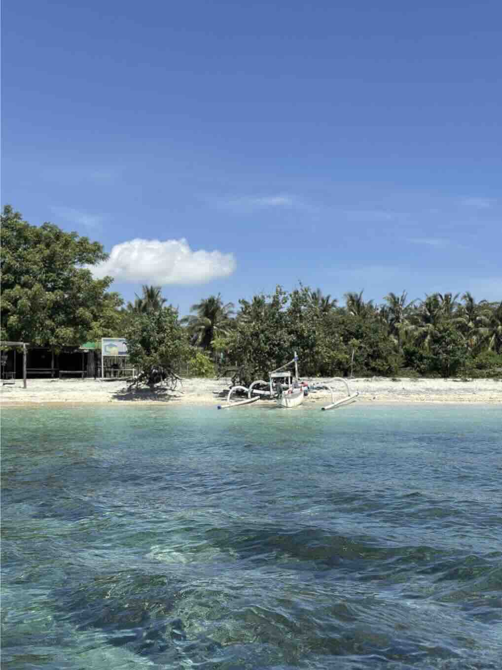 Clear turquoise water and quiet beach on Gili Asahan in southwest Lombok, Indonesia