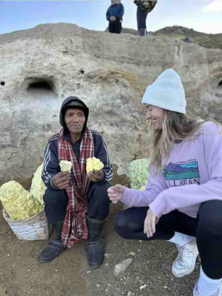 Traveler meeting a sulfur miner near Kawah Ijen volcano in East Java, Indonesia