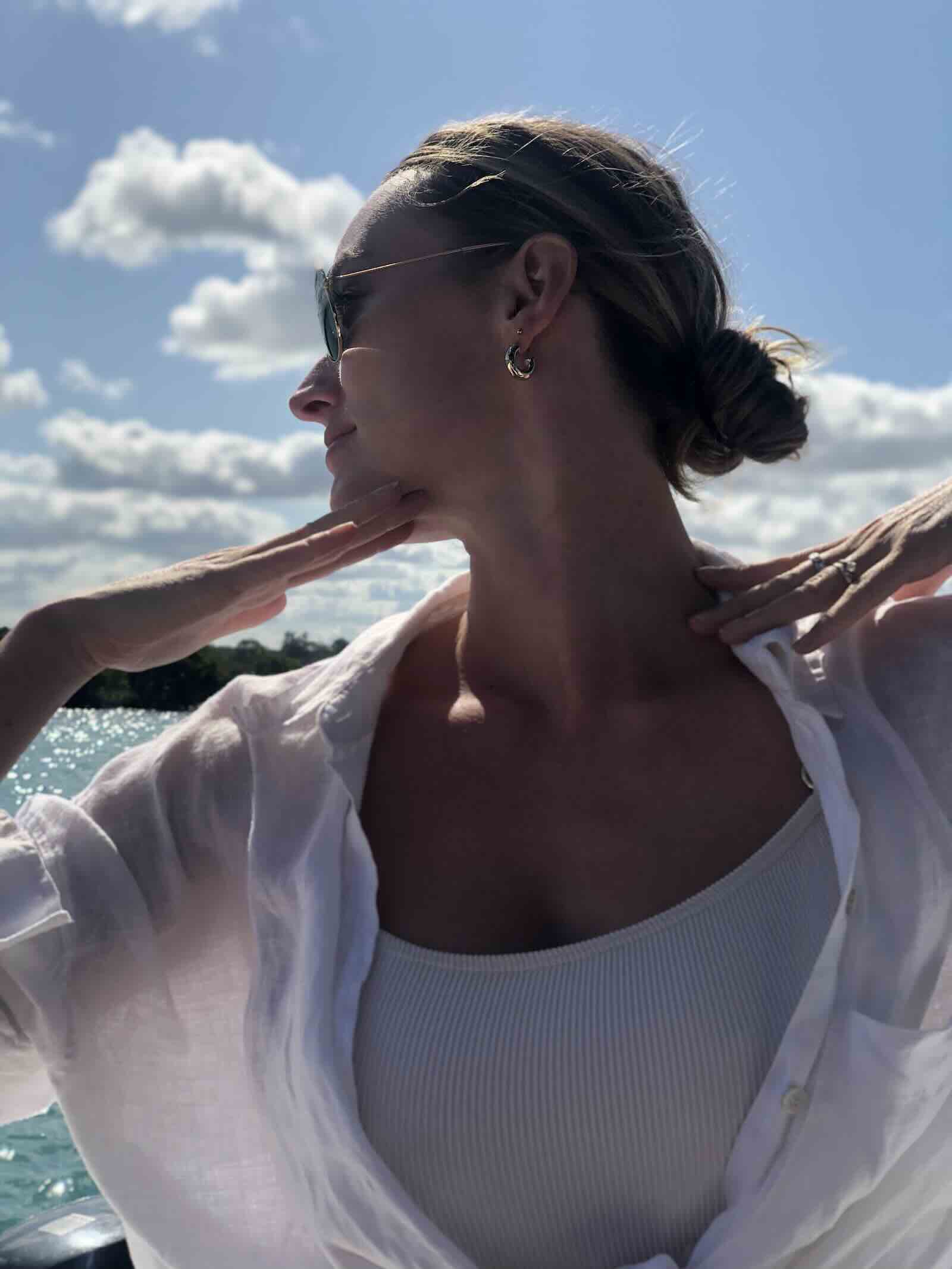 Traveller receiving a shoulder massage aboard a private luxury boat in Mauritius.