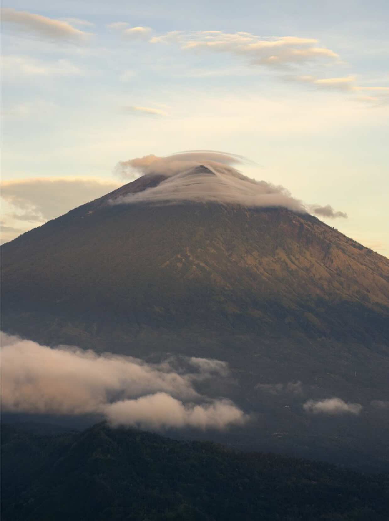 Mount Agung volcano rising above the clouds in Bali, Indonesia