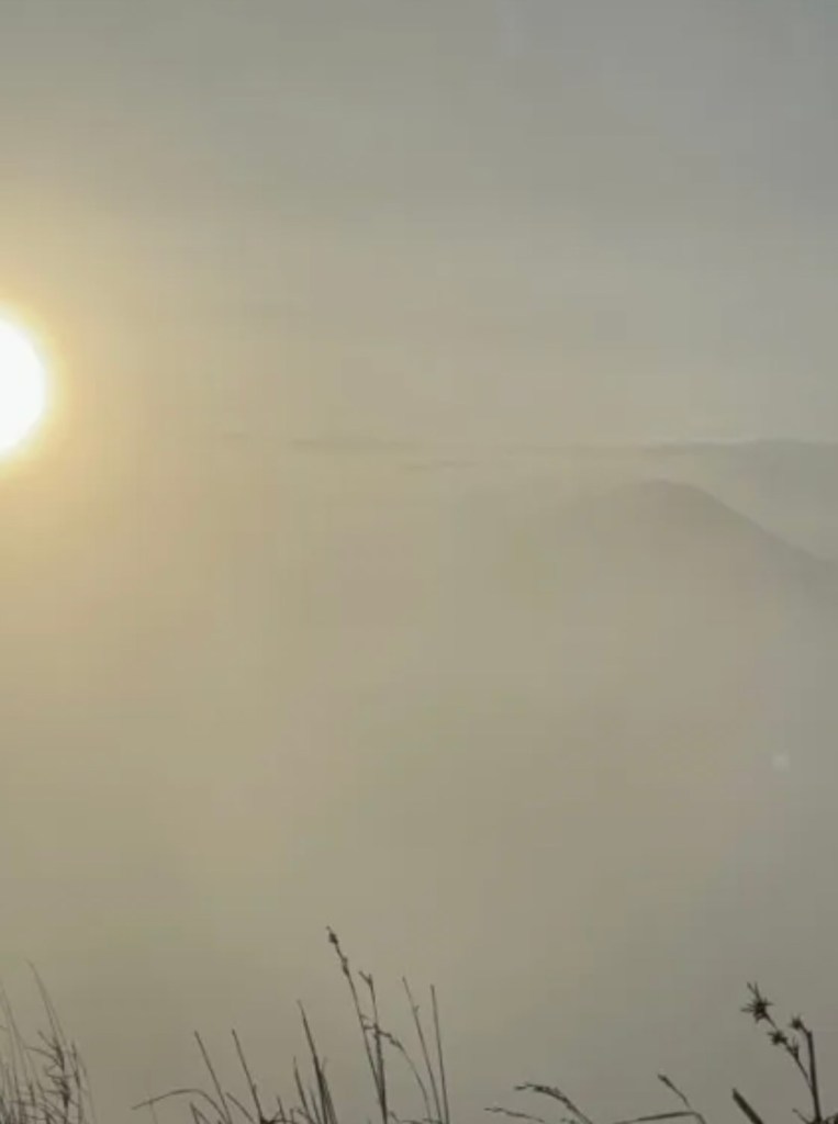 Misty sunrise view from the summit of Mount Batur in Bali