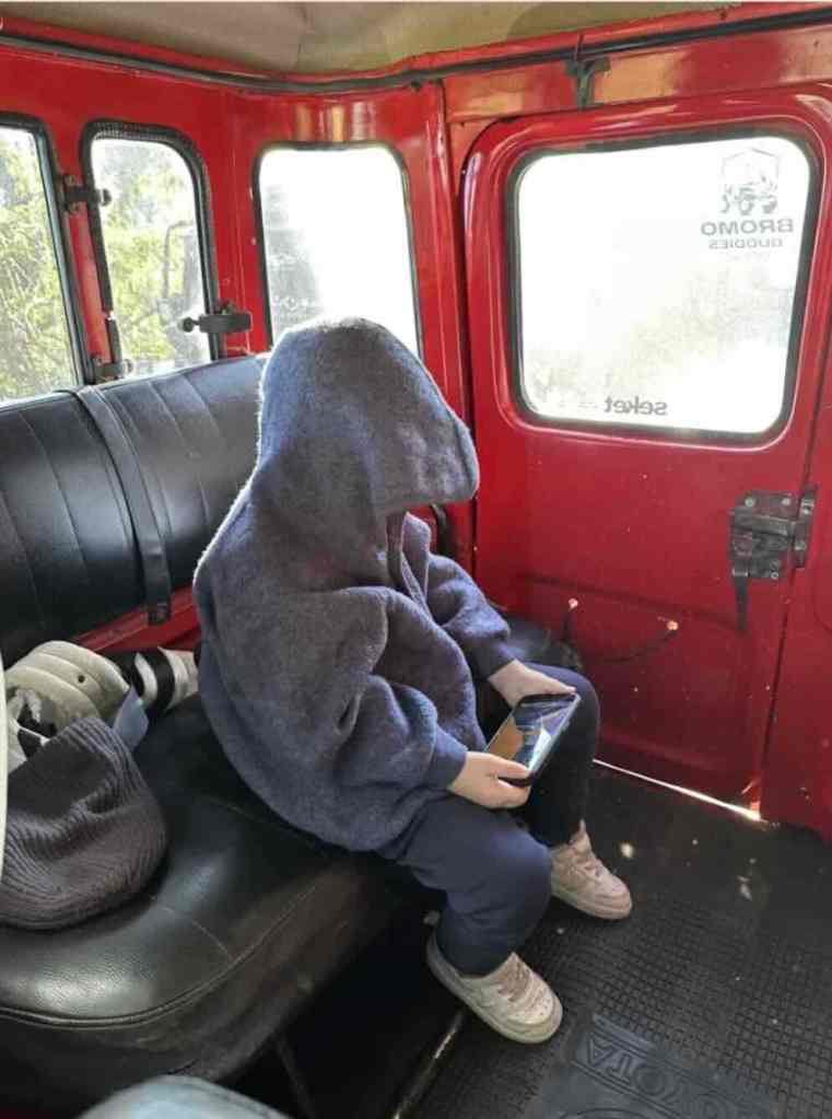 Traveler inside a red jeep during a Mount Bromo sunrise tour in East Java