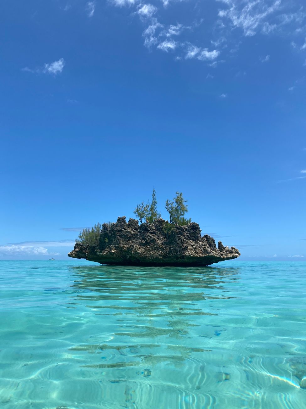 Crystal Rock surrounded by shallow turquoise water off the southwest coast of Mauritius.