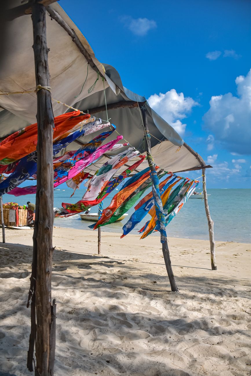 Colourful beach umbrellas providing shade along Flic en Flac Beach in Mauritius.