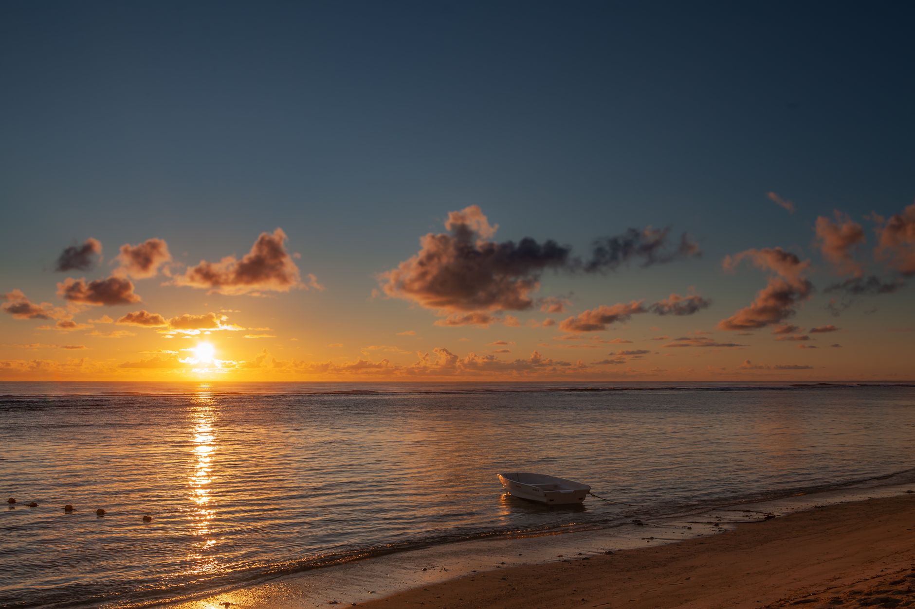Sunset over the calm lagoon at Trou aux Biches Beach in Mauritius.