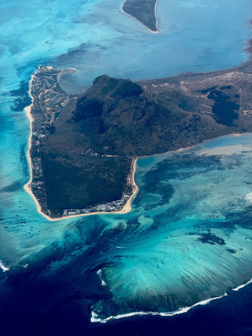 Helicopter view of Le Morne Peninsula and the Underwater Waterfall illusion in Mauritius.