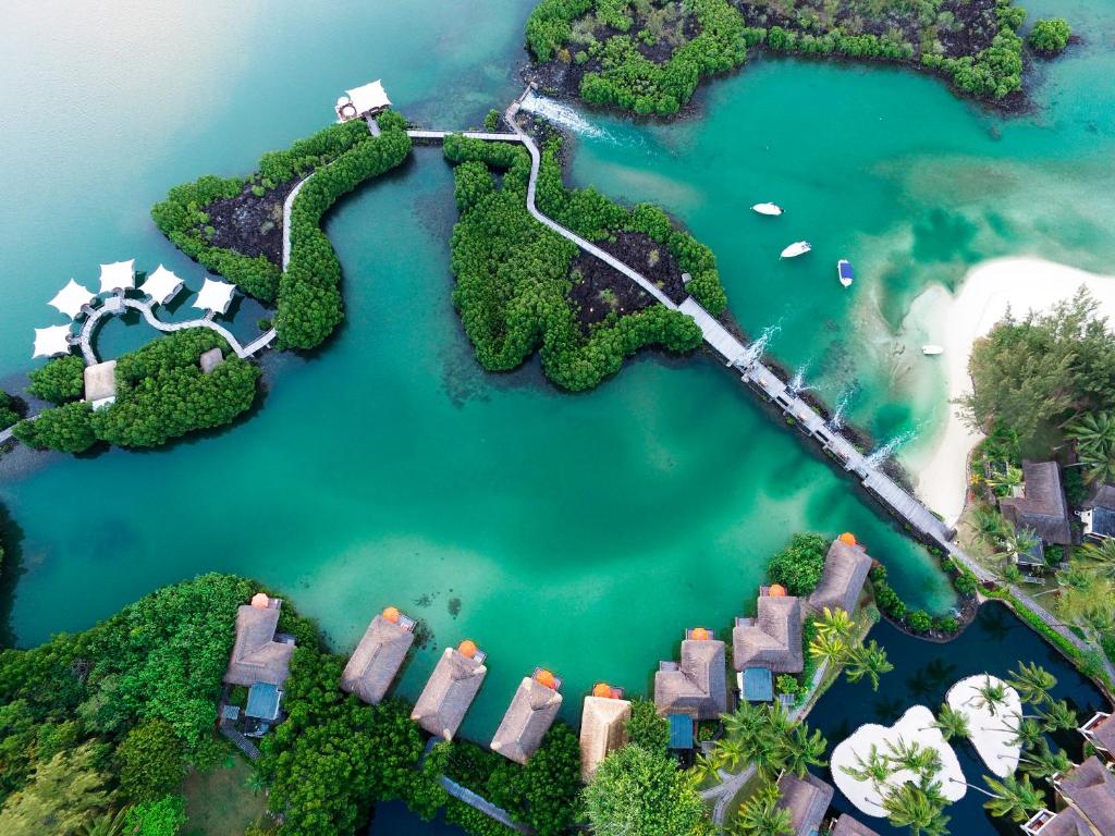 Aerial view of Constance Prince Maurice villas surrounded by mangroves and turquoise lagoons.
