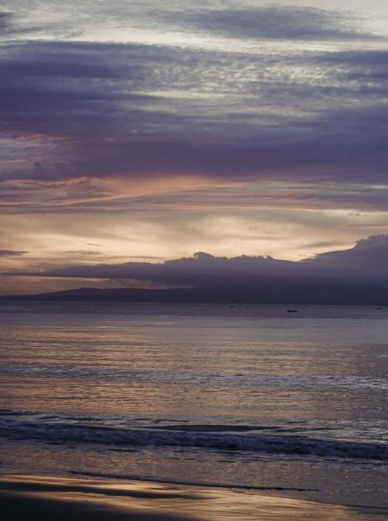 Soft sunset sky over the ocean along Sanur Beach in Bali
