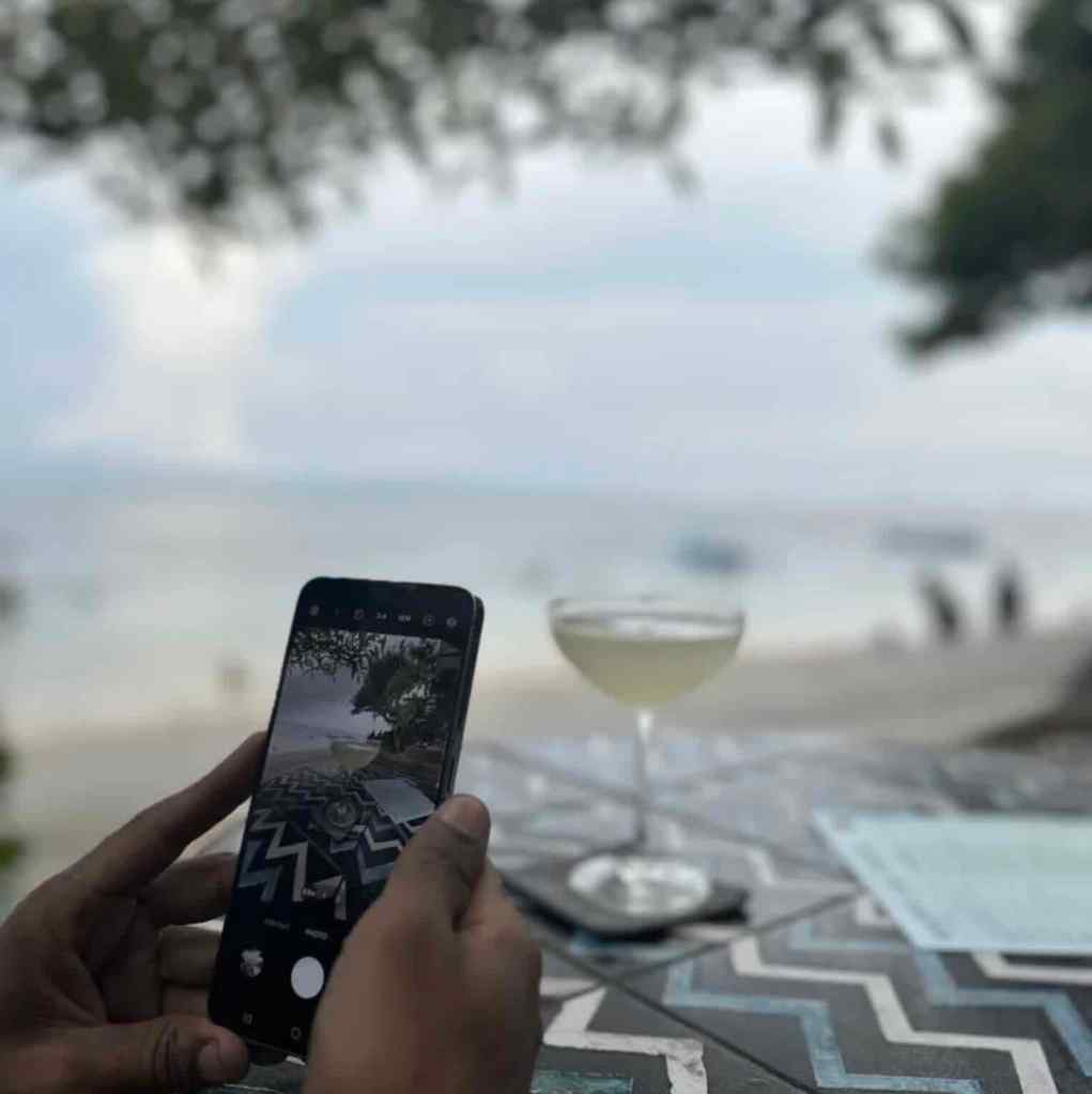 Beachfront restaurant view with drinks and ocean scenery in Sanur, Bali