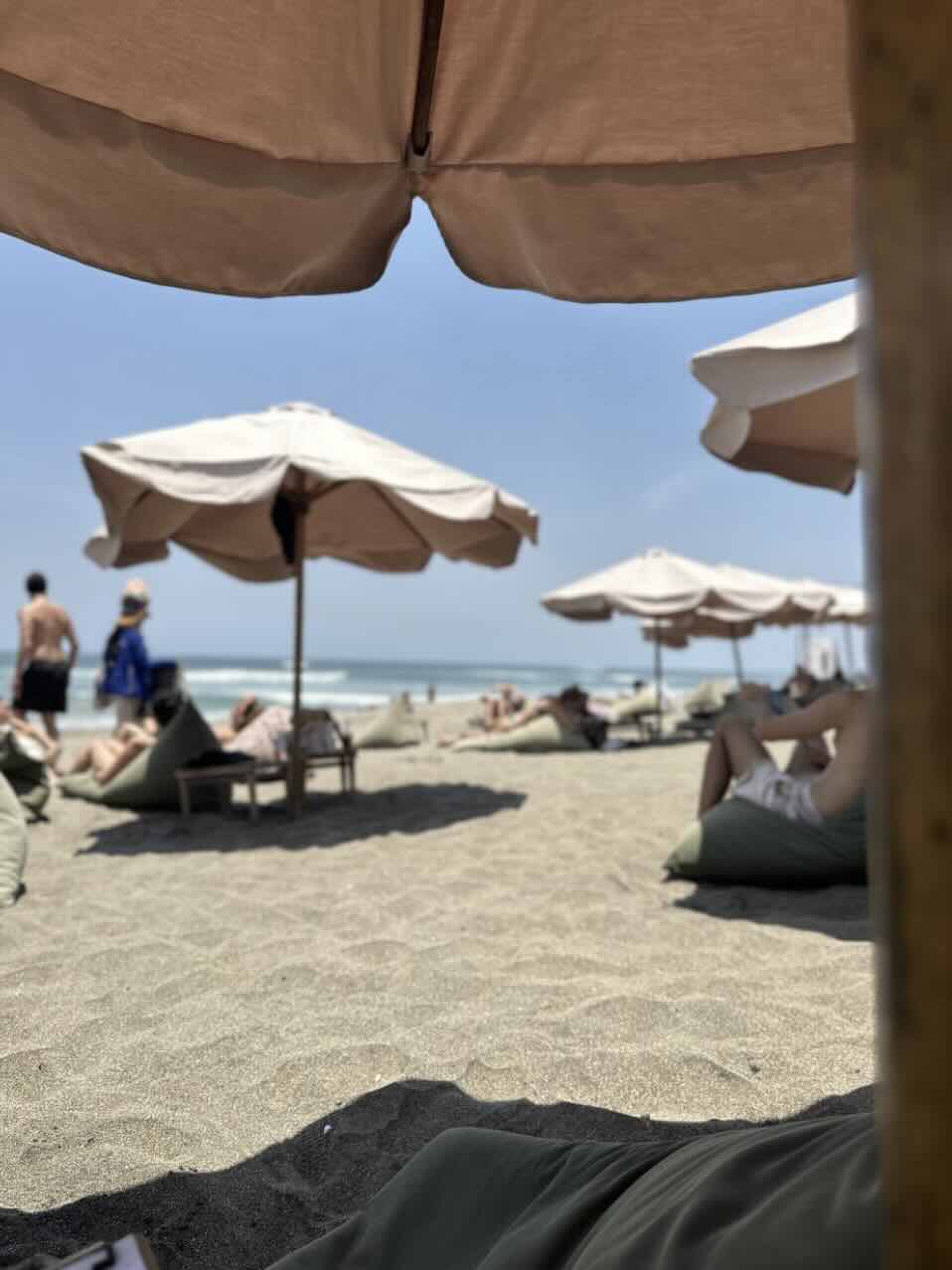 Beach loungers and umbrellas on the sand in Seminyak, Bali
