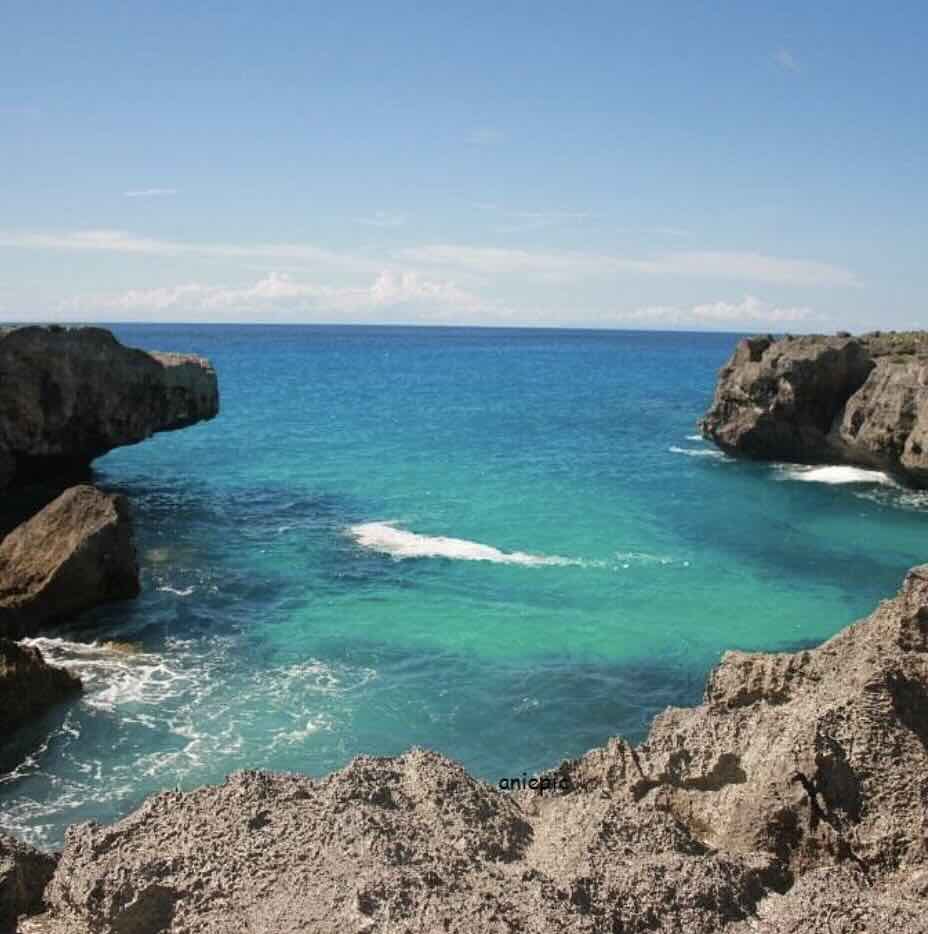 Mandorak Beach in West Sumba with turquoise water, rocky cliffs, and a small dramatic cove.