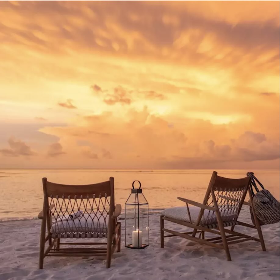Sunset on the south coast of Sumba with beach chairs, golden sky, and a peaceful ocean view.