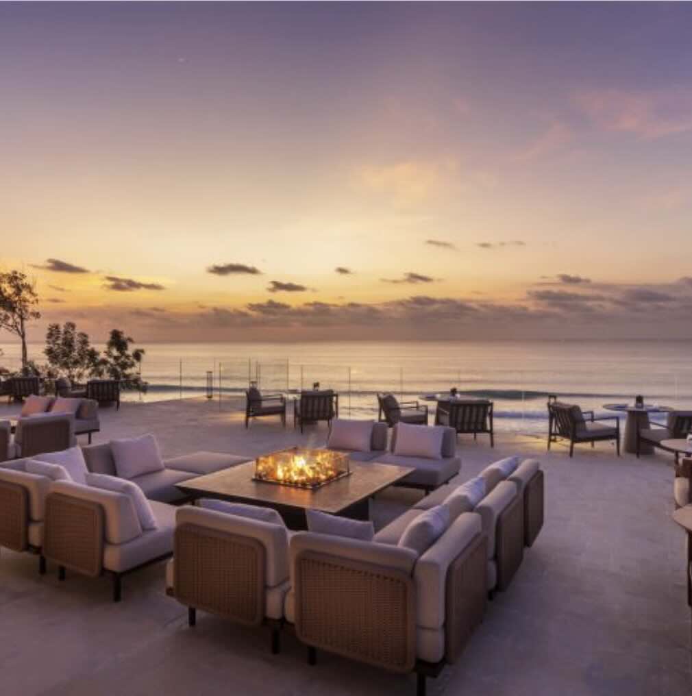 Outdoor restaurant terrace with sunset ocean views in Uluwatu, Bali