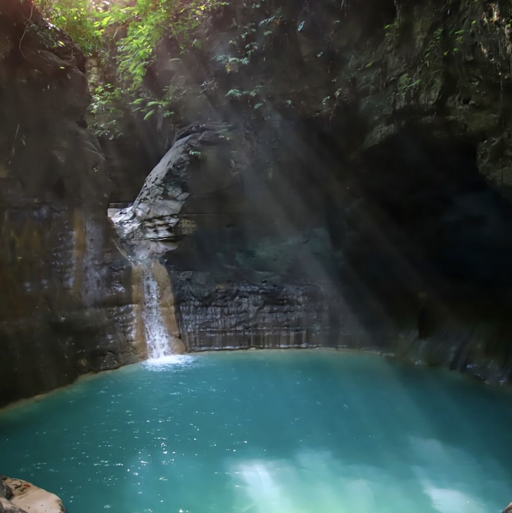 Waimarang Waterfall in East Sumba with turquoise water, rocky cliffs, and a peaceful natural pool.