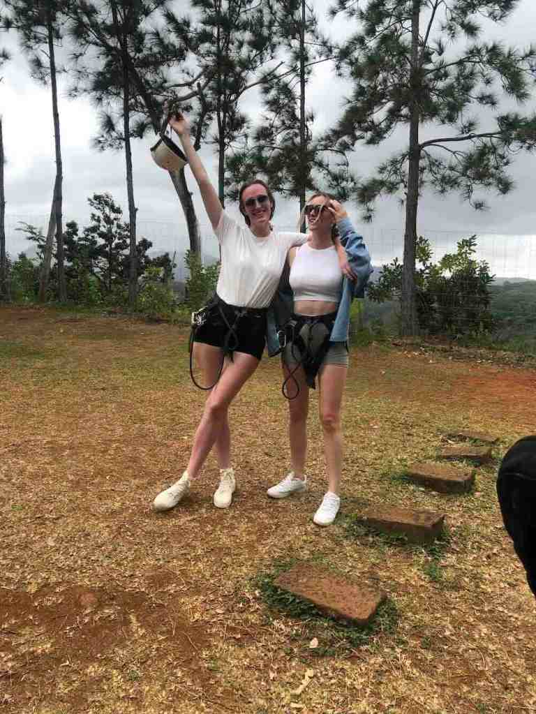Two women standing at the zipline launch platform inside Casela Nature Parks, Mauritius.