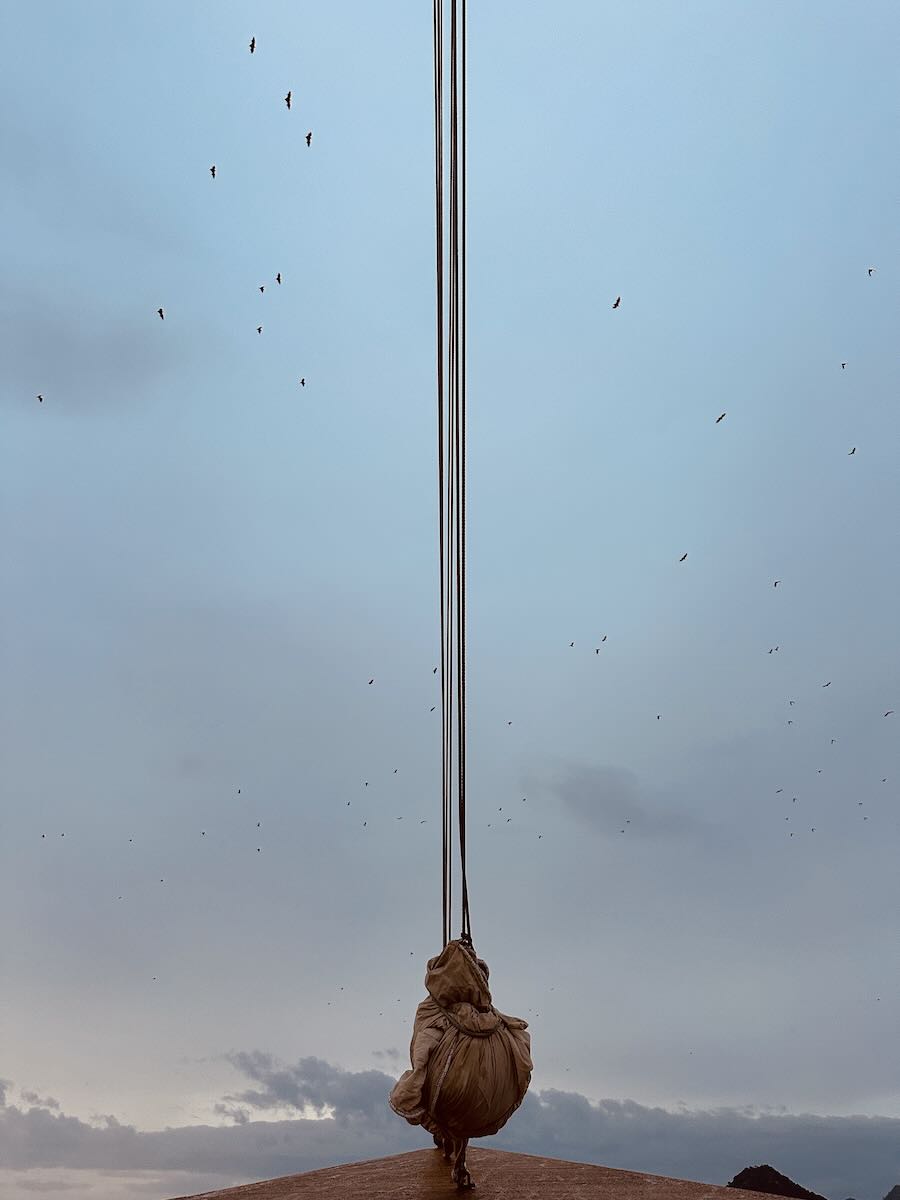 Phinisi rigging and rope detail against the evening sky near Kalong Island.