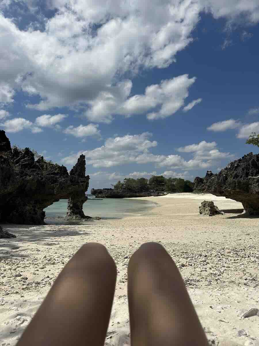 Remote white-sand beach surrounded by dramatic rock formations in Sumba, Indonesia