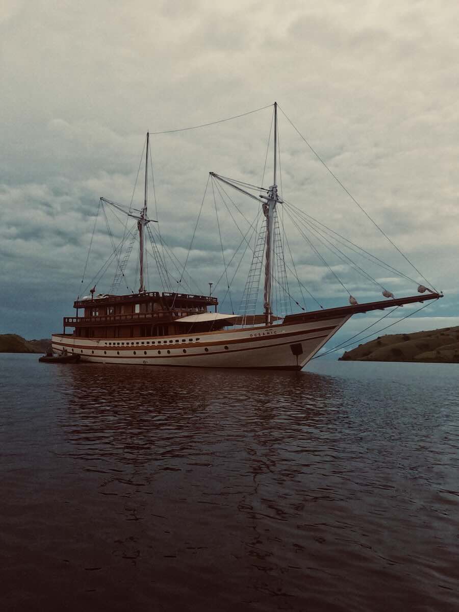 MAJ Oceanic traditional Phinisi liveaboard anchored between the islands of Komodo National Park.