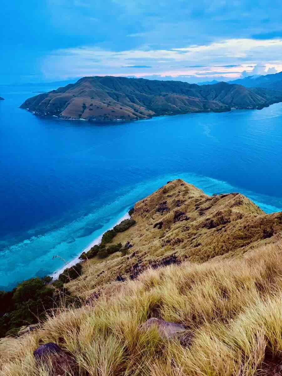 Turquoise bay and surrounding islands viewed from the top of Gili Lawa Darat.