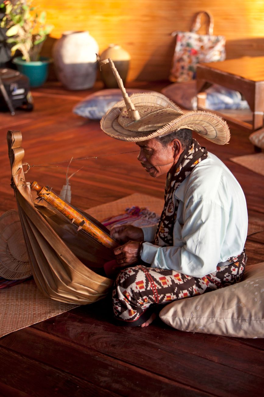 Rotenese musician playing a traditional sasando instrument in Rote Island