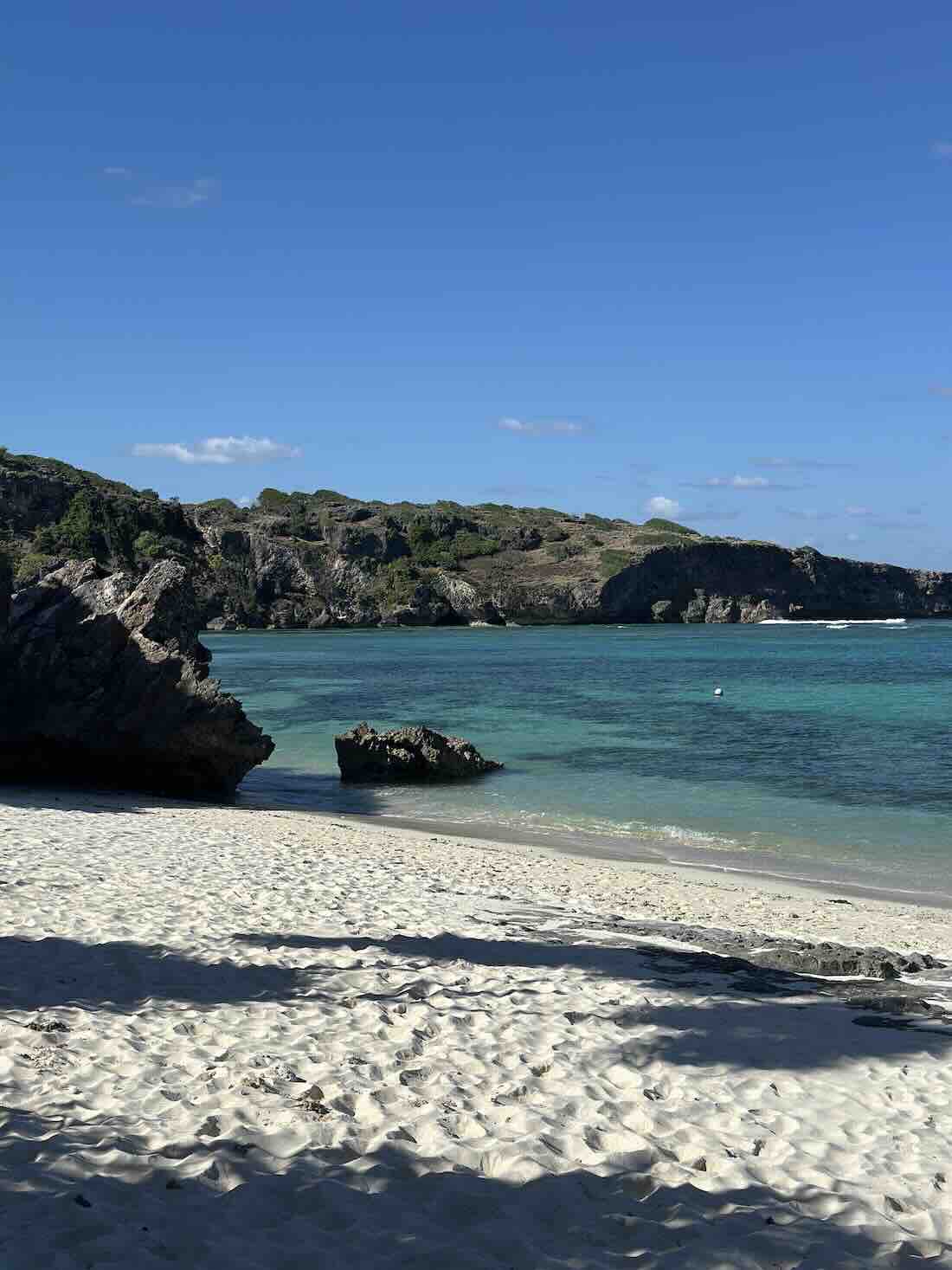 Quiet white-sand beach with clear turquoise water in Rote Island, Indonesia