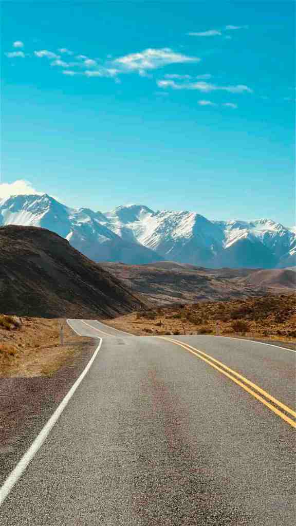 Winding alpine road leading toward the Southern Alps near Arthur’s Pass.