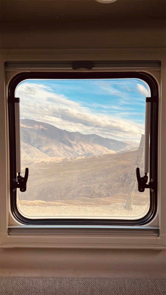 Mountain and lake views from inside our campervan during our New Zealand South Island road trip, one of the best parts of travelling the island by motorhome.
