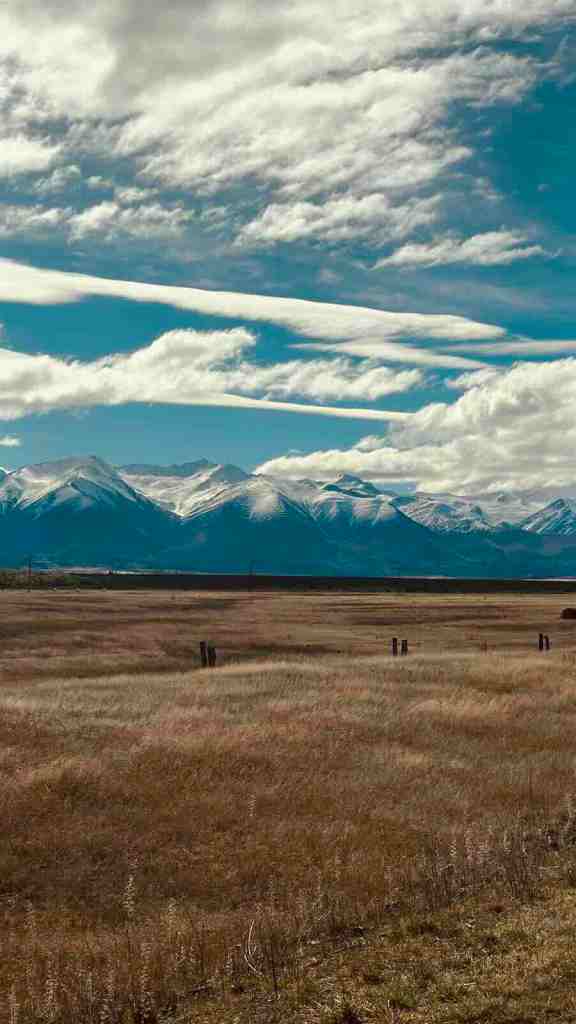 Lake Pūkaki stretching toward snow-covered mountains beside SH80 Mount Cook Road.