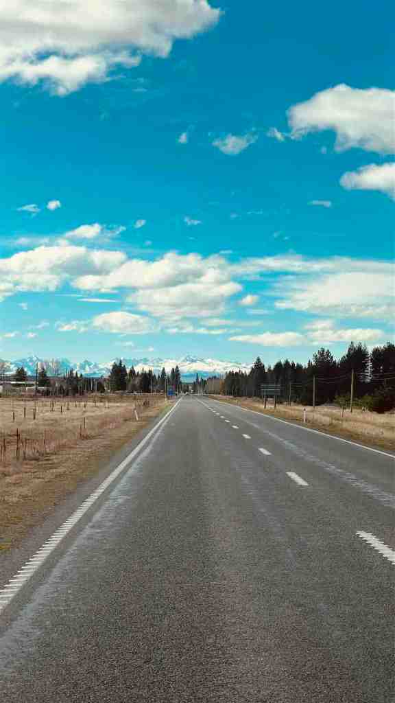Long straight section of SH80 leading toward the Southern Alps on Mount Cook Road.
