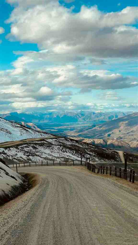 Driving through snow-covered alpine scenery during our September New Zealand South Island road trip, when road and weather conditions could change by the hour.