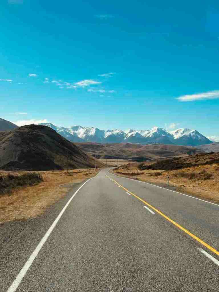 An open road leading towards the Southern Alps during our New Zealand South Island road trip, where the drive itself was often as beautiful as the destination.