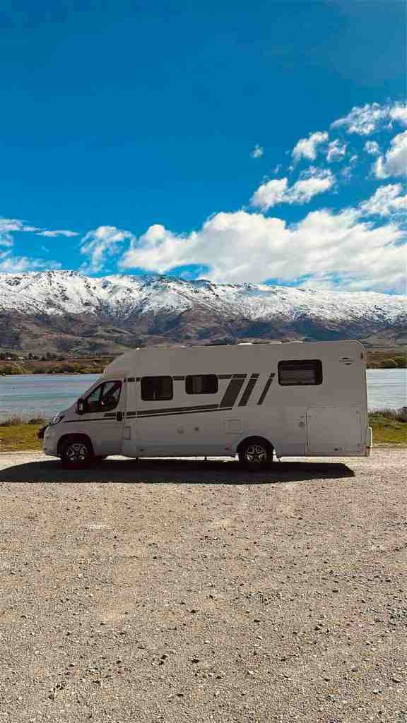 Our motorhome parked beside a turquoise alpine lake during our road trip through New Zealand’s South Island.