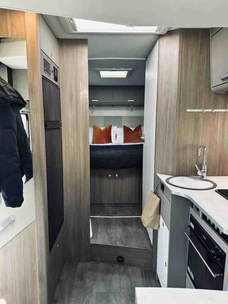 The interior of our Wilderness motorhome with kitchen, storage, bathroom and sleeping area during our New Zealand South Island campervan trip.